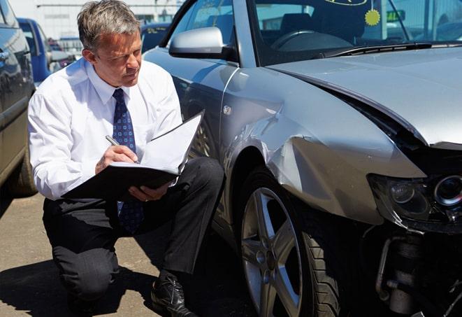 auto insurance policy certificate next to car keys